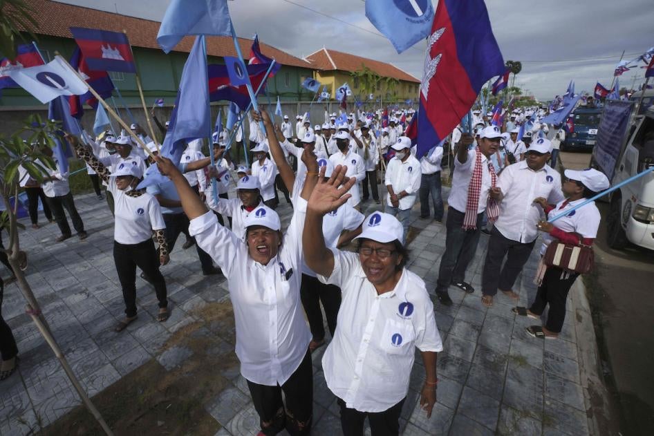 Cambodia's Candlelight Party supporters wave before marching during an election campaign for the June 5 communal elections in Phnom Penh, Cambodia, May 21, 2022.