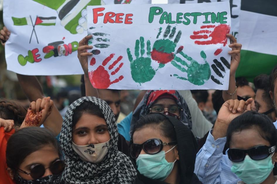 Demonstrators hold placards that read "Free Palestine"