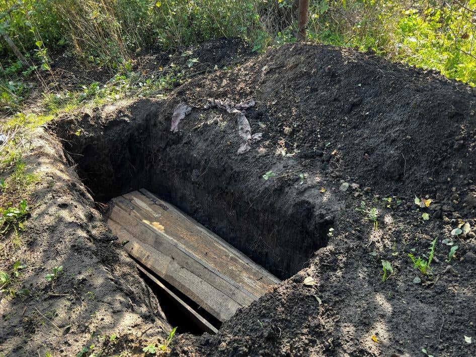 A cluster munition attack in March 2022 on the left bank of the Siverskiy Donets River killed one woman and injured her mother while they were cooking outside their house. Neighbors buried the woman in her yard. 