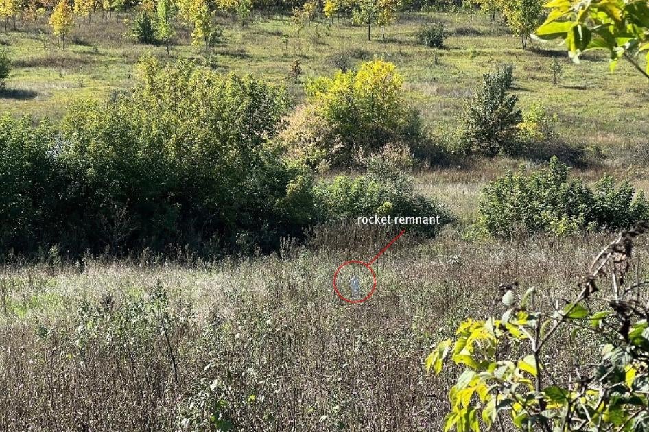 The carrier section of an 9M27K-series Uragan rocket lodged in the ground near a family’s home in Hlynske village, apparently fired from the west, where Ukrainian forces controlled territory while the area was under Russian occupation in 2022.  Each rocket delivers 30 9N210 or 9N235 submunitions.