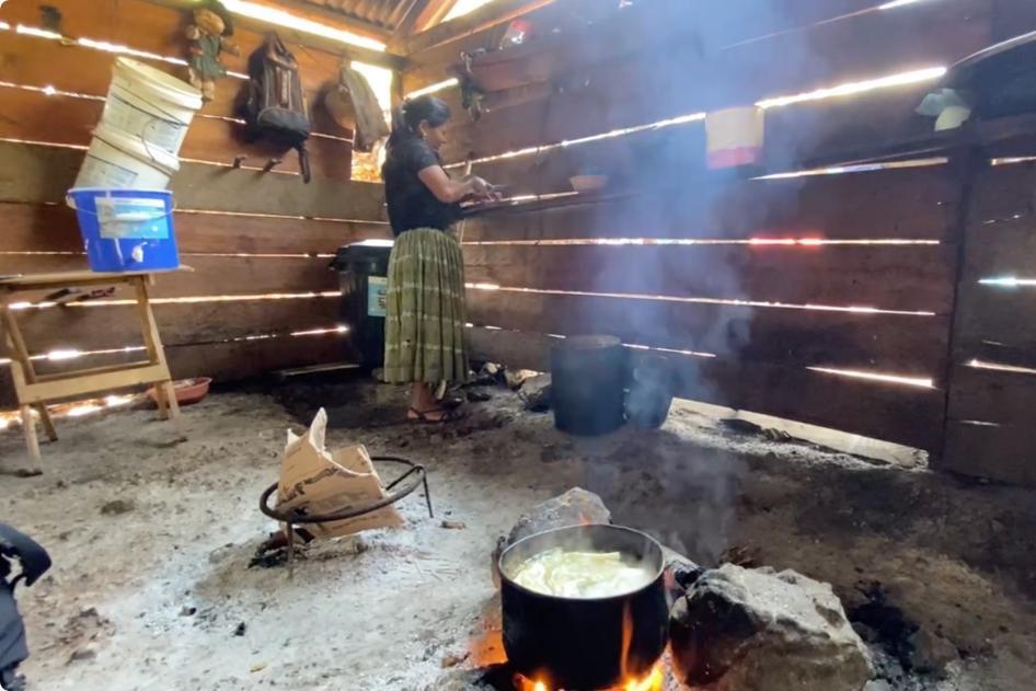 A woman cooks in a kitchen in a home built by her family member