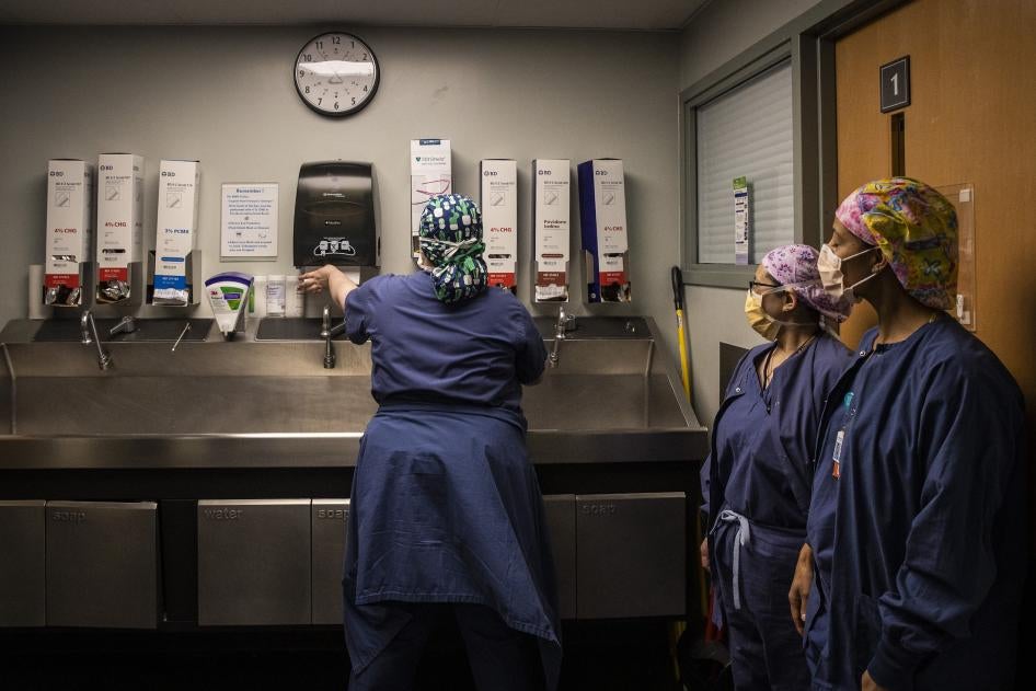 Surgical Technicians wash their hands after exiting an operating room at Newton-Wellesley Hospital in Newton, Massachusetts, US on April 22, 2022. 