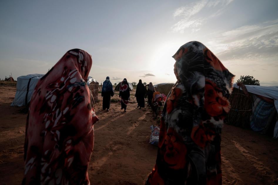 Survivors of sexual violence, who fled the fighting in El Geneina, in Sudan’s Darfur region, outside their makeshift shelters in Adre, Chad, August 1, 2023. © 2023 REUTERS/Zohra Bensemra