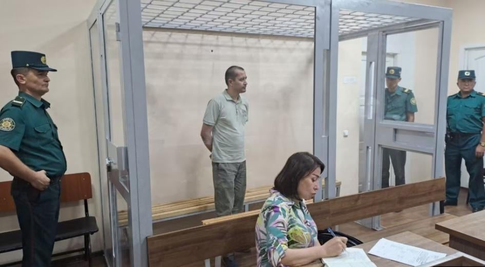 Abduqodir Muminov in the defendant's cage in a courtroom in Tashkent, Uzbekistan, July 2023.
