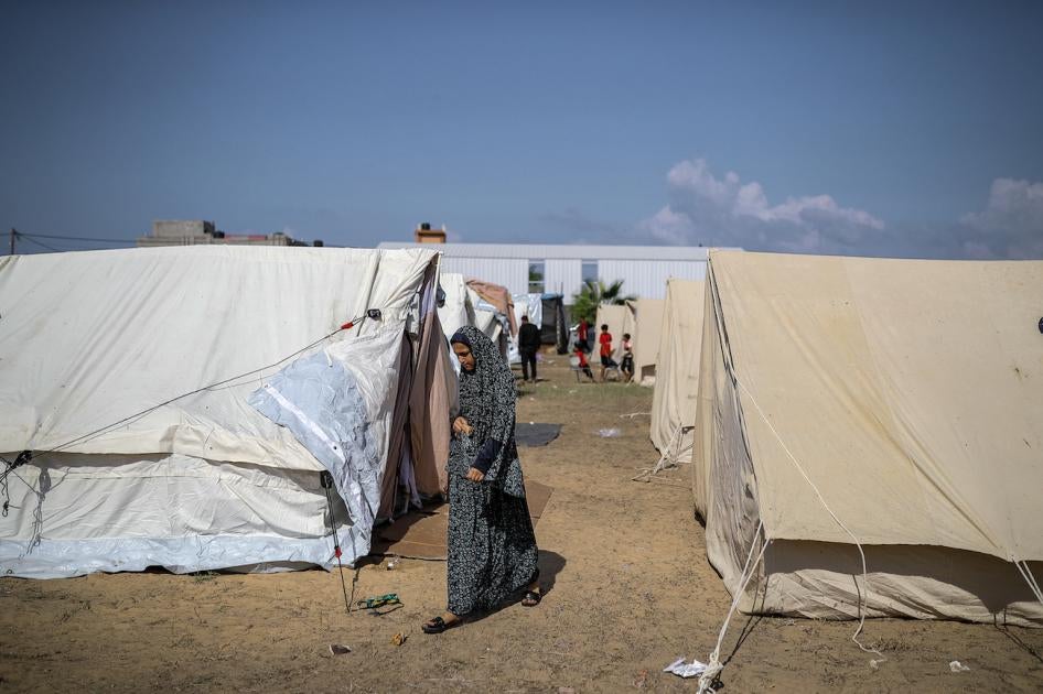 A girl walks around tents at a camp set up by the United Nations Relief and Works Agency for Palestine Refugees (UNRWA) for Palestinians who fled to the southern Gaza Strip, October 19, 2023. 