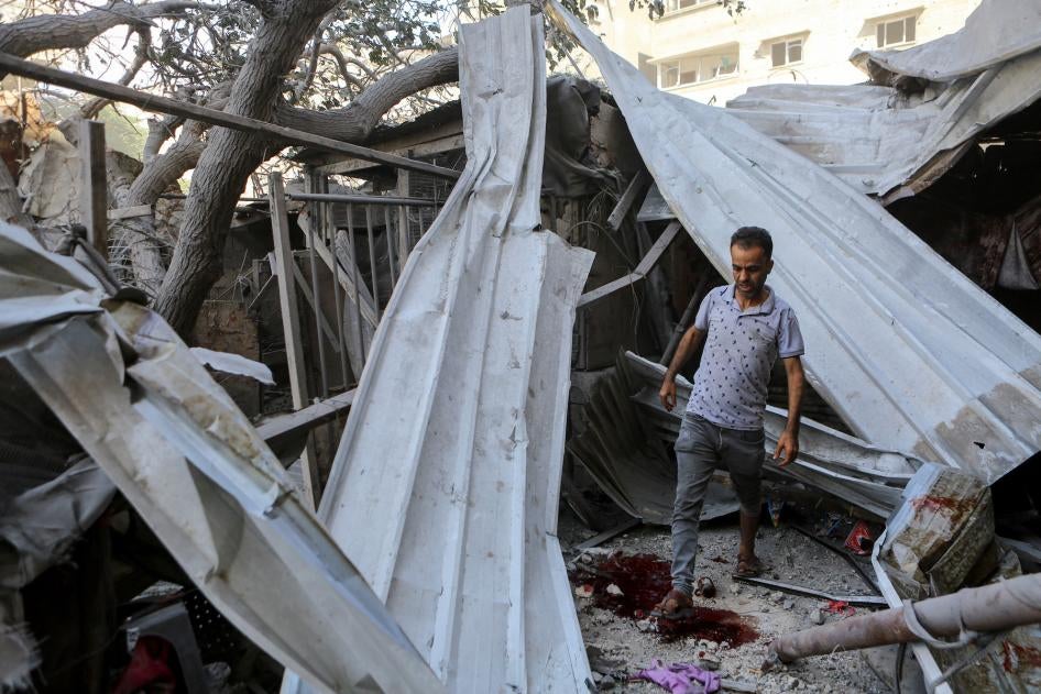 A man walks through the rubble of Israeli strikes in Gaza City, October 15, 2023. 