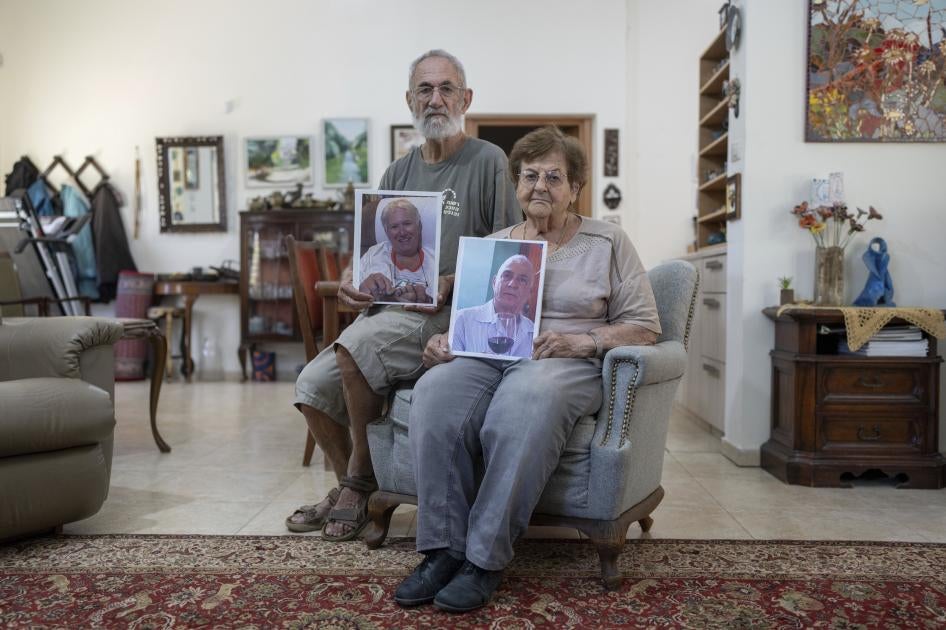 Chanan and Edna Choen, hold up portraits of his sister, 77-year-old Margalit Moses, and her husband, 79-year-old Gadi Moses in their family home in Lakhish, Israel, October 30, 2023. The older Moses couple were abducted by Hamas-led fighters from their home in the kibbutz of Nir Oz on October 7, 2023. 
