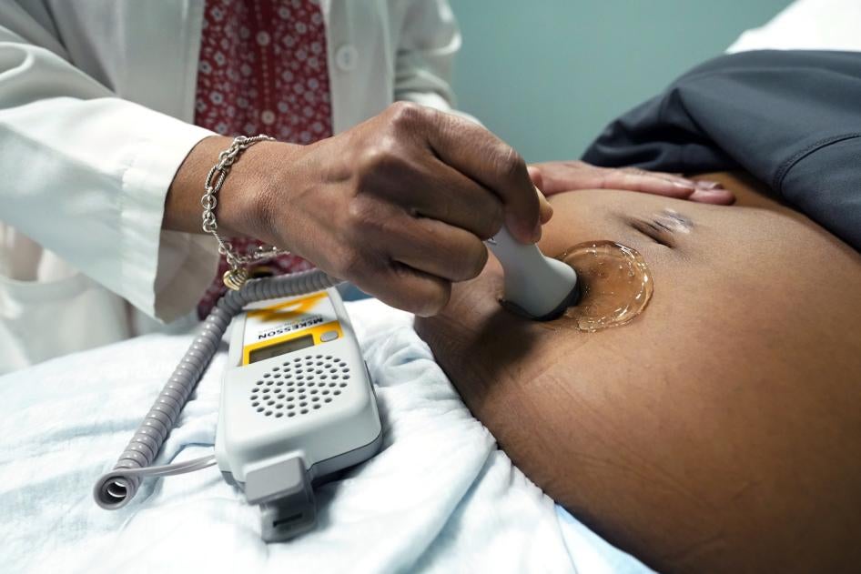 A doctor examines a pregnant woman to measure the heartbeat of the fetus, Jackson, Mississippi, US, December 17, 2021. 