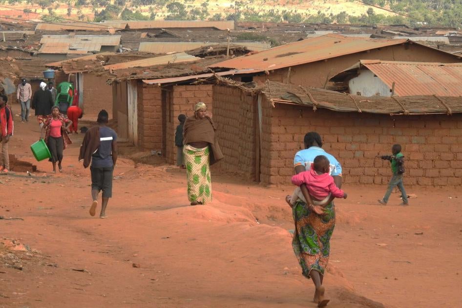 People walk through Dzaleka refugee camp in Dowa district, Central Region, Malawi, on June 20, 2018.