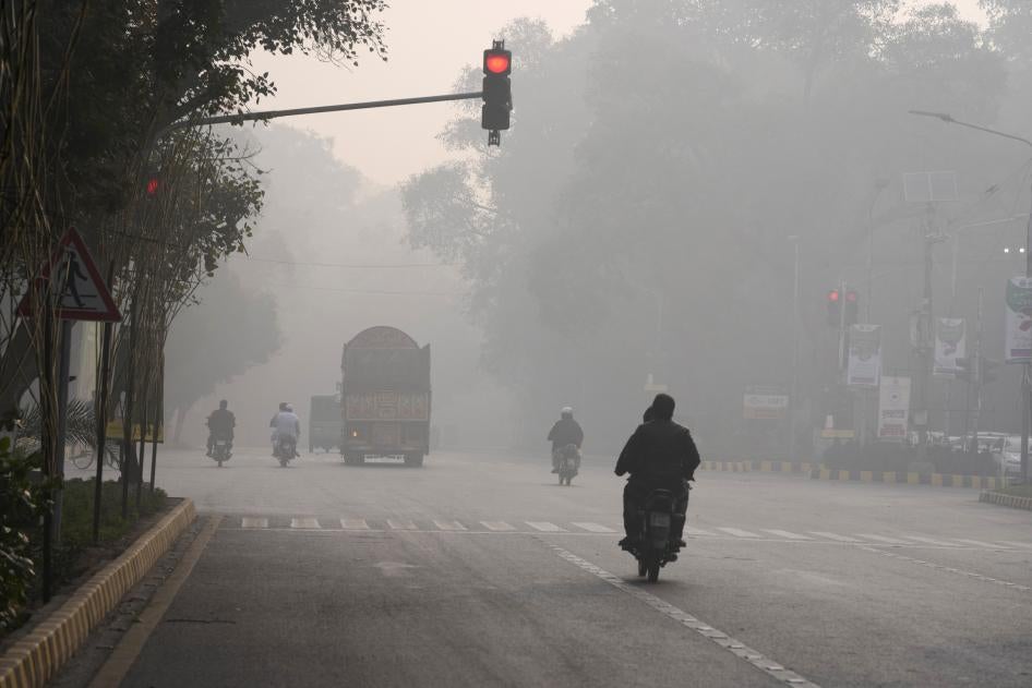 Vehicles and motorcyclists amid severe air pollution in Lahore, Pakistan, November 24, 2023.