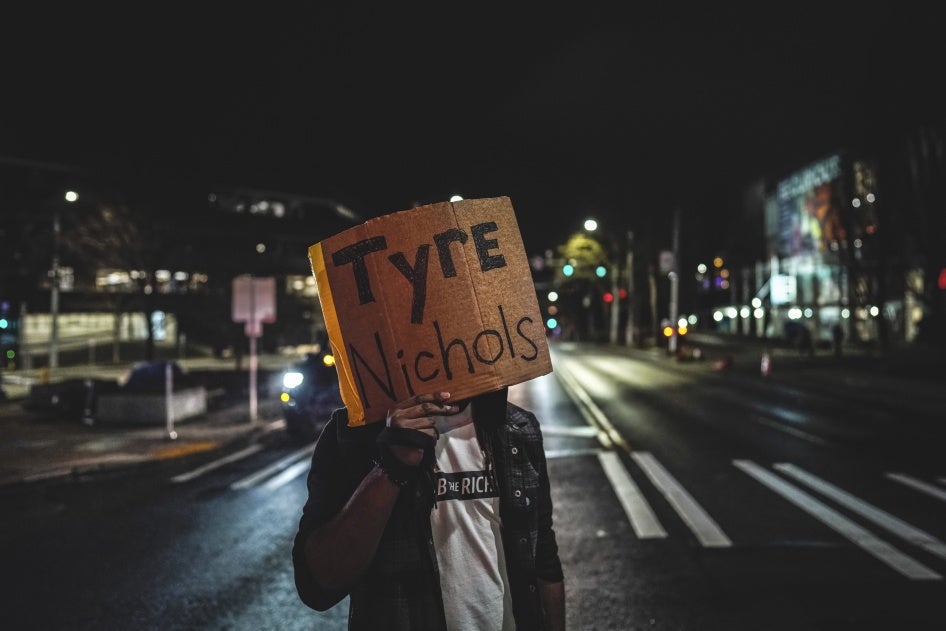 A protester holds a placard with the name Tyre Nichols, killed in January 2023 by five police officers in Memphis, Tennessee, during a demonstration in Seattle, Washington, January 27, 2023.