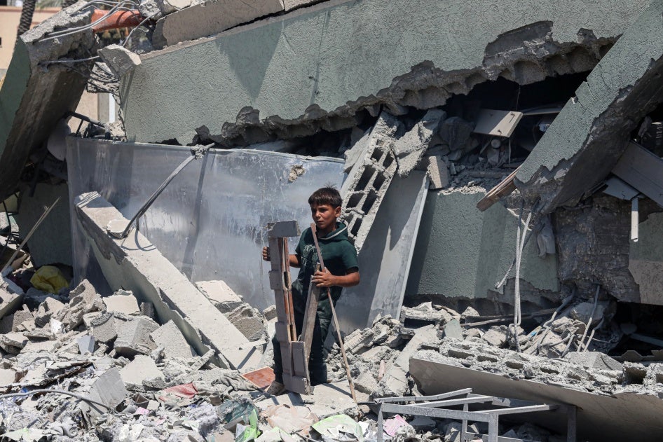A boy stands on the rubble of Khadija School in Deir al-Balah, central Gaza, which an Israeli airstrike hit on July 27, 2024, killing at least 15 displaced Palestinians.