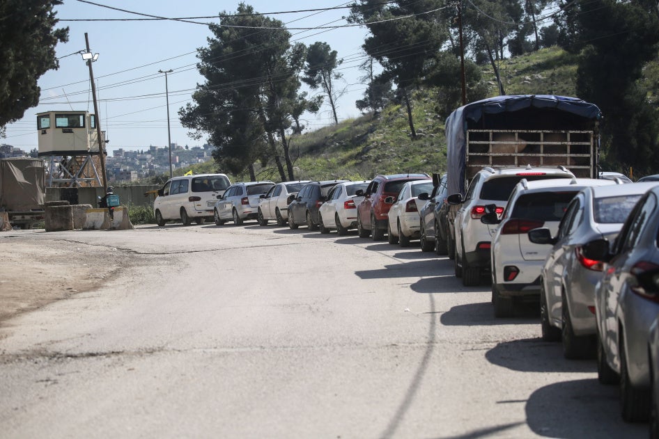 Palestinians wait to cross at the Israeli Awarta military checkpoint on March 23, 2025, south of Nablus in the West Bank.