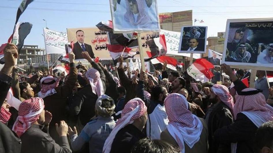 People shout slogans while holding placards, banners and national flags, during a demonstration asking for the release of Sunni lawmaker Ahmed al-Alwani in Ramadi, Iraq on January 25, 2014.