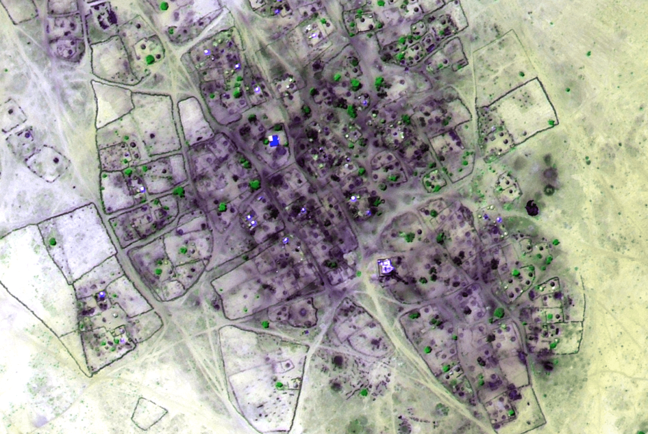 False-color infrared satellite image of the village of Um Gunya recorded after the government offensive in late February 2014, shows extensive areas of housing destruction and evidence of burnt vegetation consistent with an arson attack. Areas of fire-rel