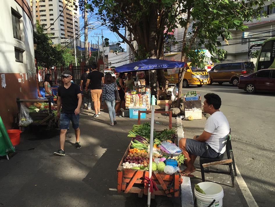 Street vendors on Vito Cruz Street in Manila, near the Philippine International Convention Center where the APEC summit will be held. Such street vendors could lose their livelihood for a week or more as streets are cleared in preparation for the APEC Sum