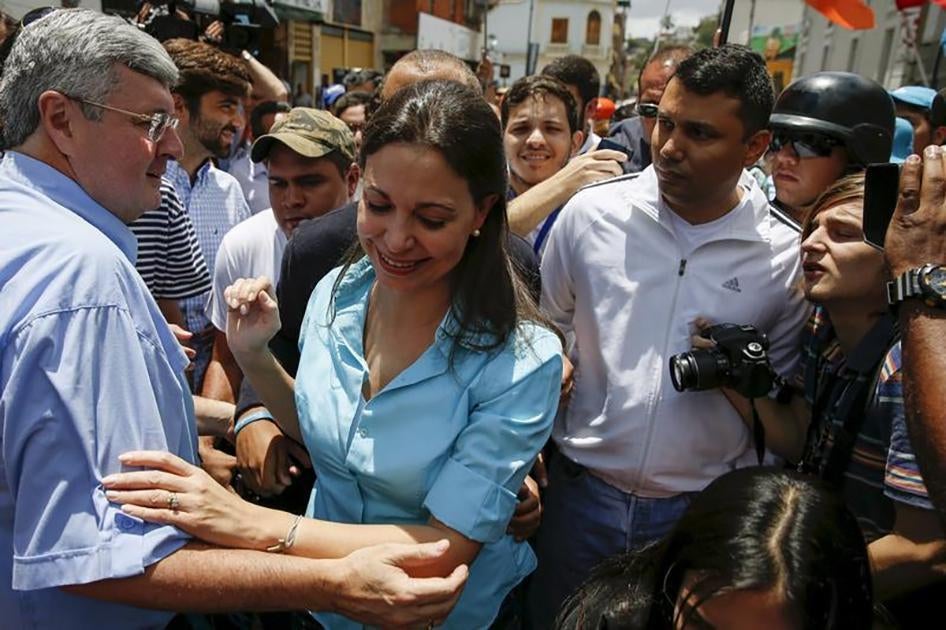 Venezuela's opposition leader Maria Corina Machado greets supporters, after trying to register her candidacy for the upcoming parliamentary elections at an office of National Electoral Council, in Los Teques, Venezuela on August 3, 2015. 