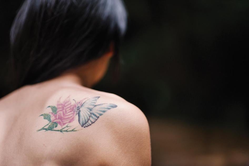 Jina, a 22-year-old transgender woman, sports a tattoo of a butterfly—a transgender symbol signifying transformation. 