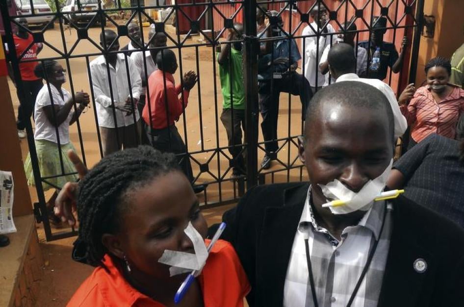 Journalists and civil society members tape their mouths shut as a protest against the closure of the premises of the Daily Monitor newspaper by the Uganda government, in the Uganda’s capital Kampala on May 20, 2013. Police raided Uganda's leading independ