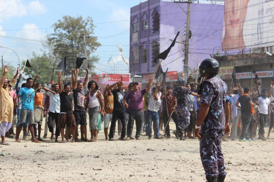 A police officer faces protesters in Nepal’s Terai region in September 2015.