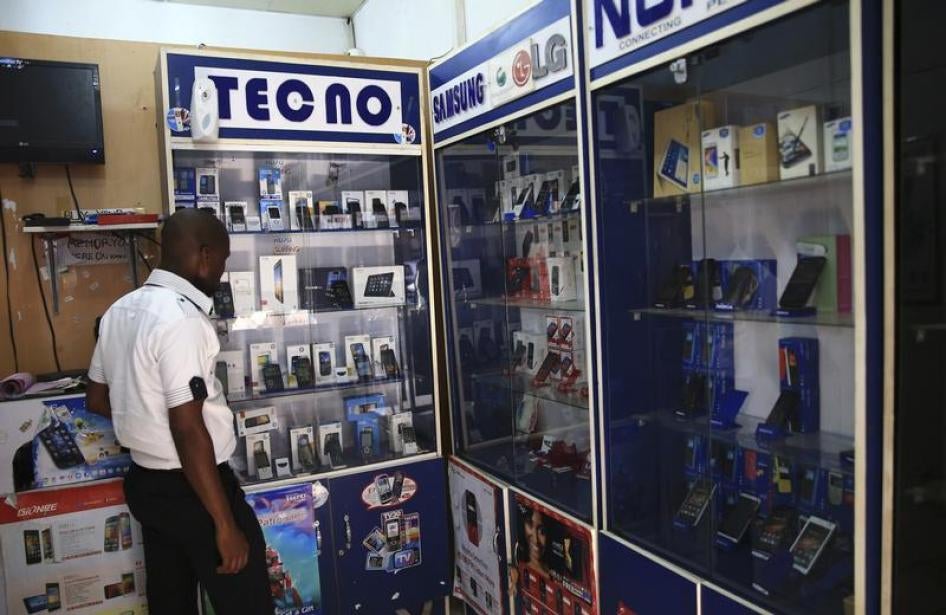 A man looks at smartphones on display at a shop at Wuse II business district in Abuja, Nigeria, December 9, 2014.