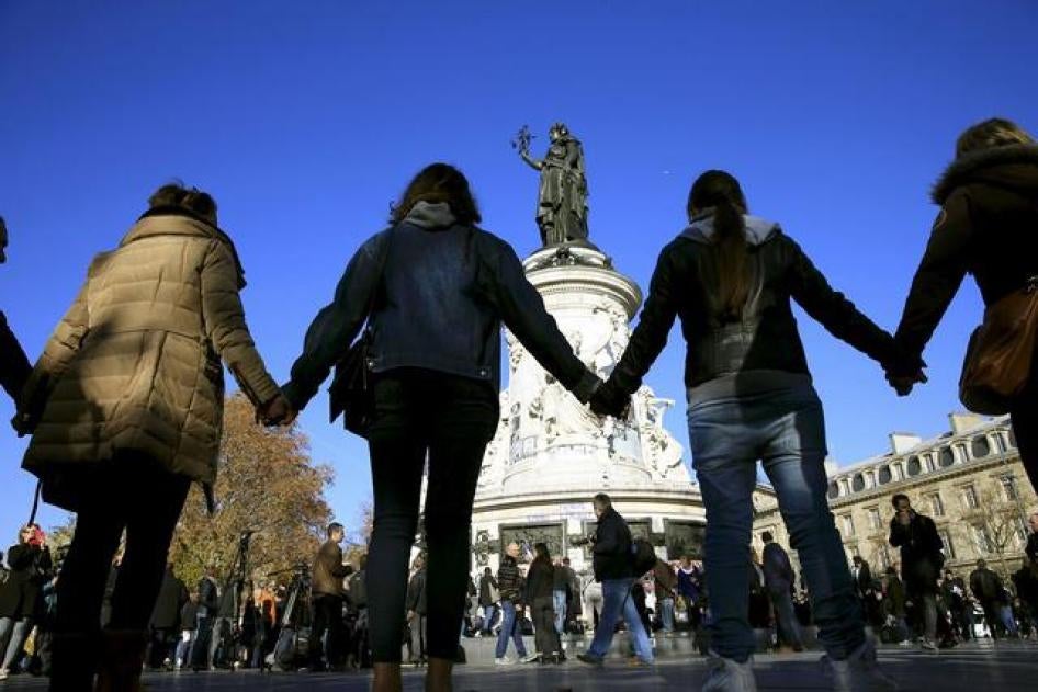 People hold hands to form a human solidarity chain near the site of the attack at the Bataclan concert hall in Paris
