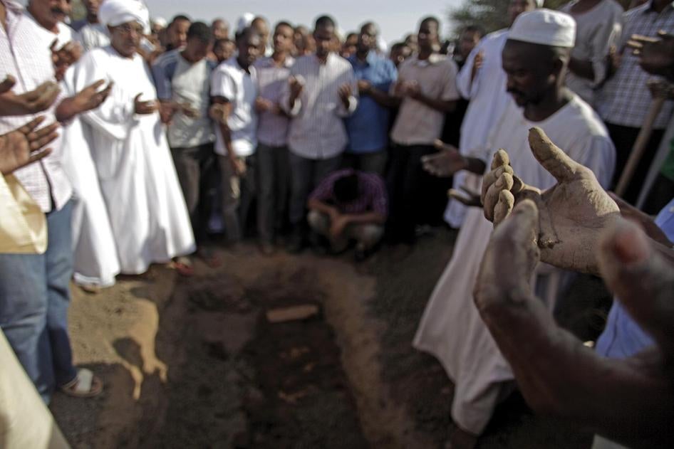 Sudanese men at the funeral of Salah Sanhouri, 26, who was killed during protests by security forces on September 27, 2013, pray over his body. Protests over subsidy cuts on fuel and food have been taking place across Sudan since September 2013.