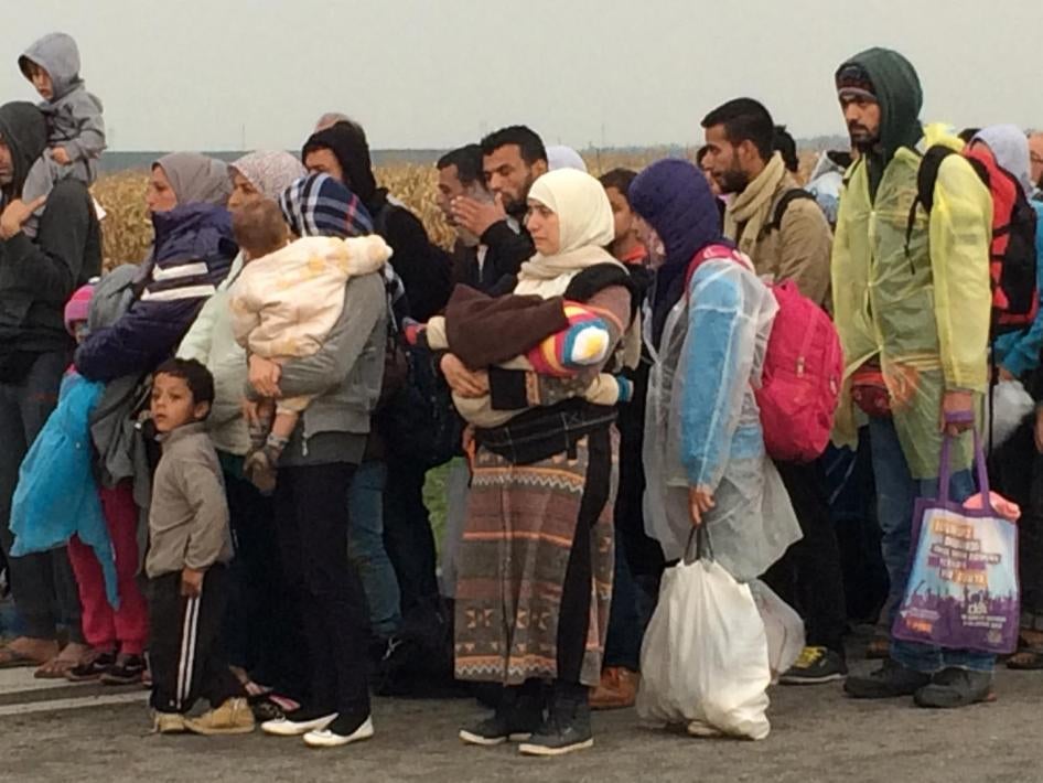 Migrants queuing outside Tovarnik