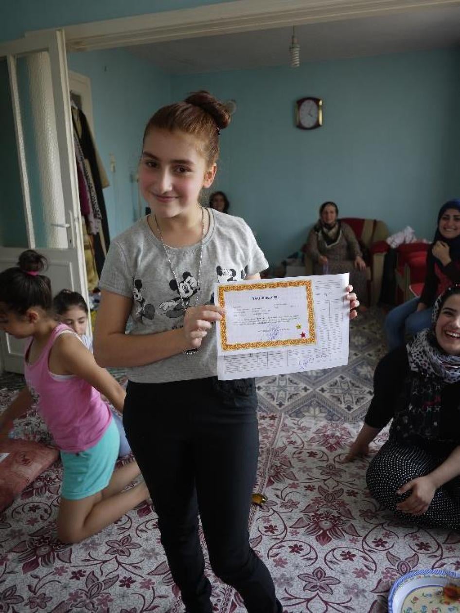 Khamleen, 14, holds a certificate showing that she finished the 7th grade at her local public school in Izmir, western Turkey, at the top of her class.