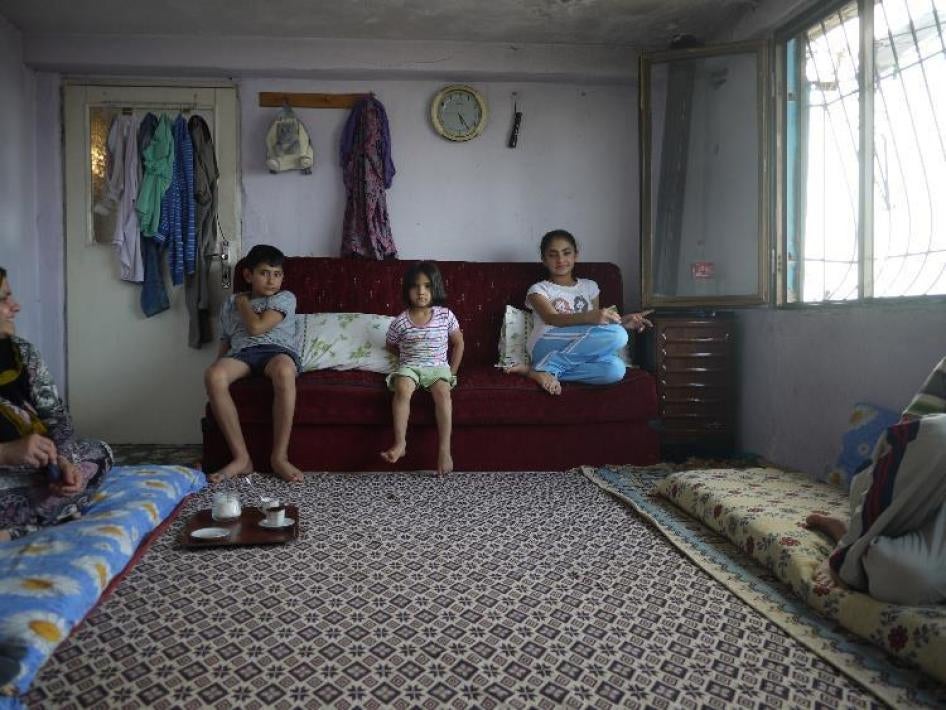 Out-of-school Syrian siblings Mohammed, 11, Sevin, 5, and Barfeen, 13, sit in their home in western Turkey.