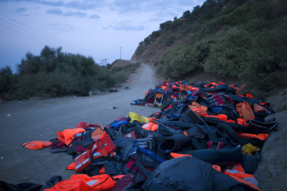 Life jackets and deflated dinghies left behind by refugees and migrants are seen on the roadside near a beach on Lesbos, Greece.
