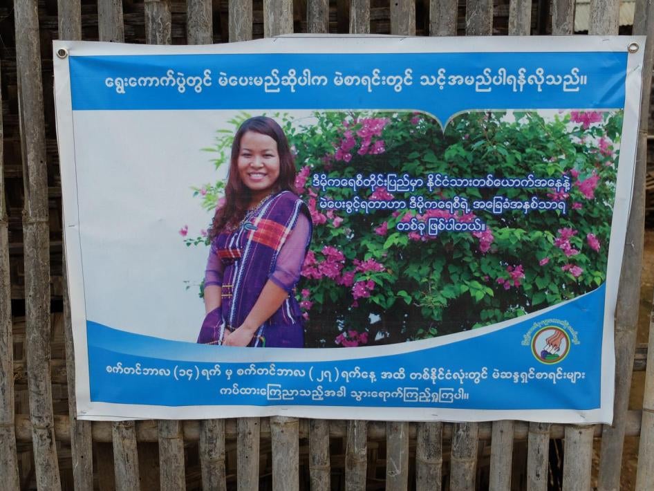 A Union Elections Commission voter awareness poster on a fence lining the road near Nyaung Shwe, Southern Shan State.