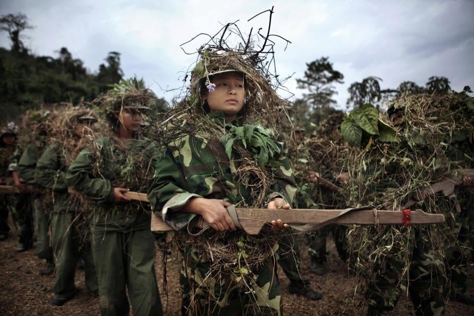 Kachin Independence Army (KIA) and militia trainees wearing camouflage and carrying wooden guns during a three-month basic training course near Laiza in KIA-controlled territory of Kachin State, January 2012. 