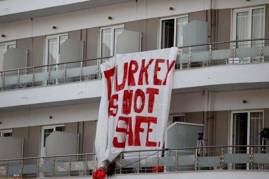 A banner hung on a hotel reads "Turkey is not safe" during a protest against the return of migrants to Turkey, at the port of Mytilene on the Greek island of Lesbos, April 4, 2016.
