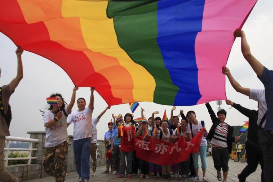 Activists raise a rainbow flag as they march during a demonstration to mark the International Day Against Homophobia and Transphobia in Changsha, Hunan province May 17, 2013.  