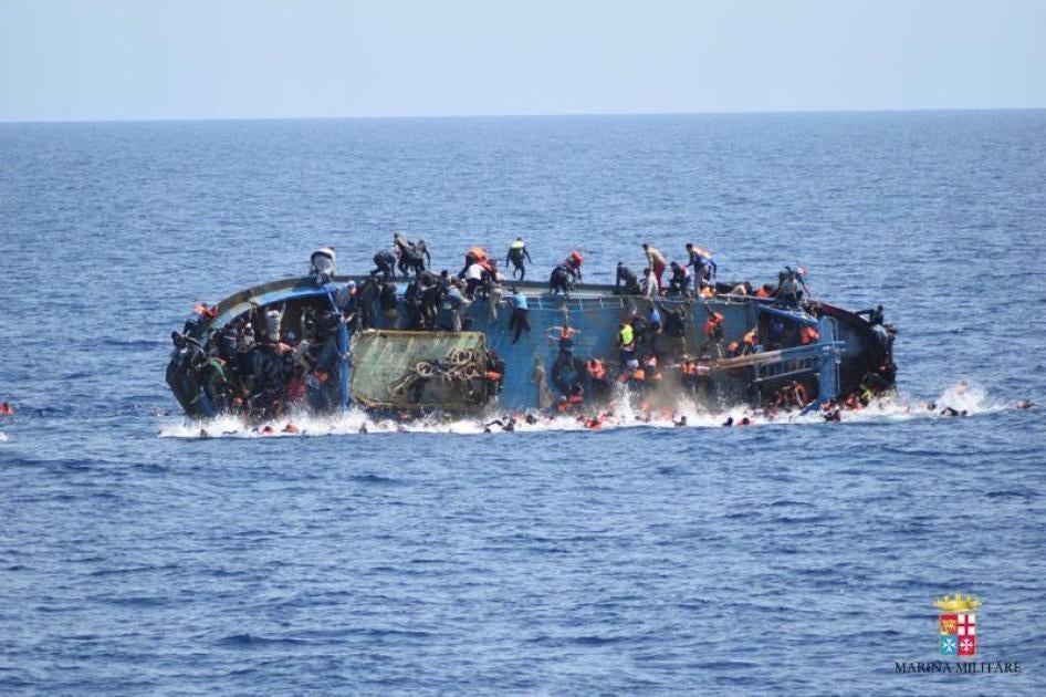 Migrants are seen on a capsizing boat before a rescue operation by Italian navy ships "Bettica" and "Bergamini" off the coast of Libya in this handout picture released by the Italian Marina Militare on May 25, 2016. 