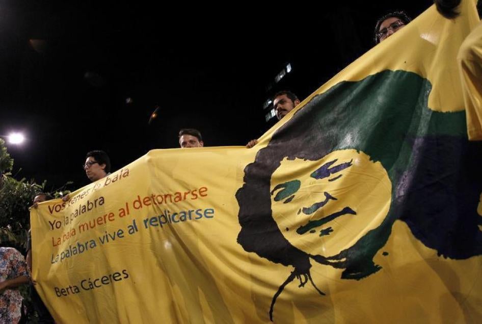 Des manifestants tiennent une banderole avec l’image de la militante écologiste hondurienne Berta Caceres lors d’un événement à San Jose (Costa Rica) marquant la Journée internationale de la femme le 8 mars 2016, cinq jours après le meurtre de cette activ
