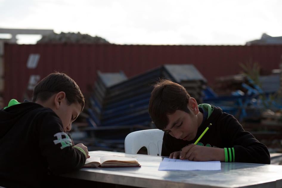 Wa’el, 13, and Fouad, 7, originally from Idlib, study outside their home in Jounieh. Their mother, Kawthar, 33, struggled to enroll them in school, and eventually withdrew them due to concerns about the quality of education and transportation costs of US$