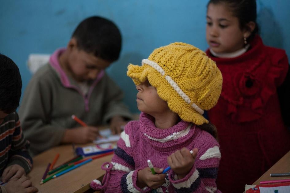 Syrian refugee children sit in a classroom in a non-formal school in the Bekaa Valley. 