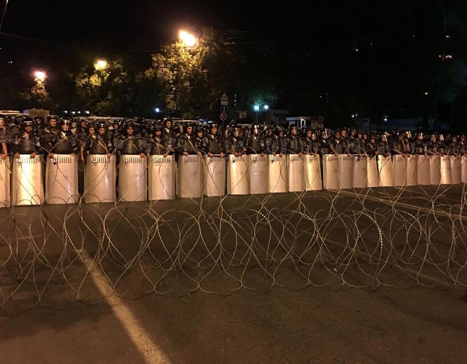 Riot police and barbed wire block protestors from marching down Baghramyan Street in downtown Yerevan on July 30, 2016. 
