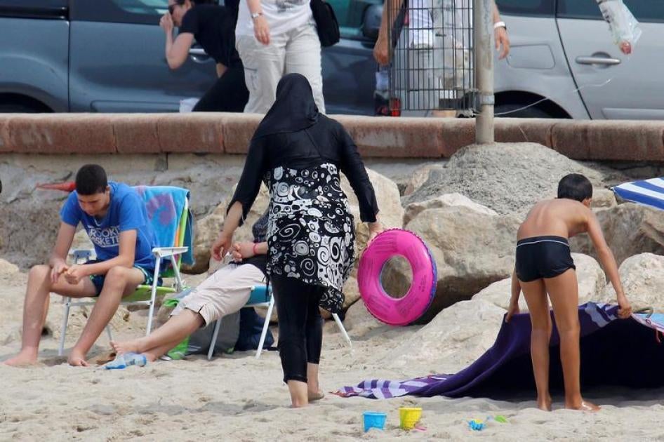 A Muslim woman wears a burkini, a swimsuit that leaves only the face, hands and feet exposed, on a beach in Marseille, France, August 17, 2016.