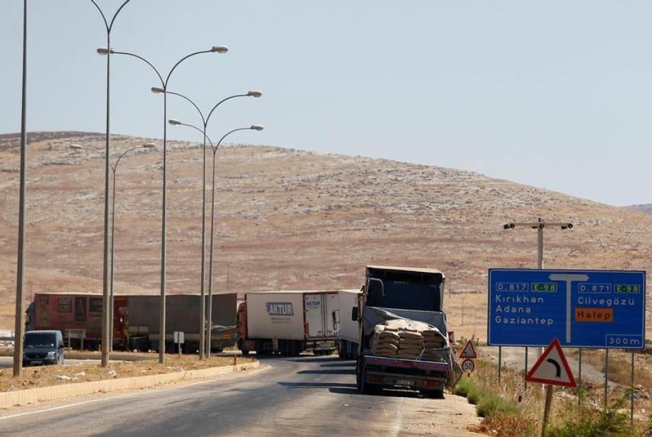 Commercial Turkish trucks wait to cross to Syria near the Cilvegozu border gate, located opposite the Syrian commercial crossing point Bab al-Hawa in Reyhanli, Hatay province, Turkey, September 16, 2016.