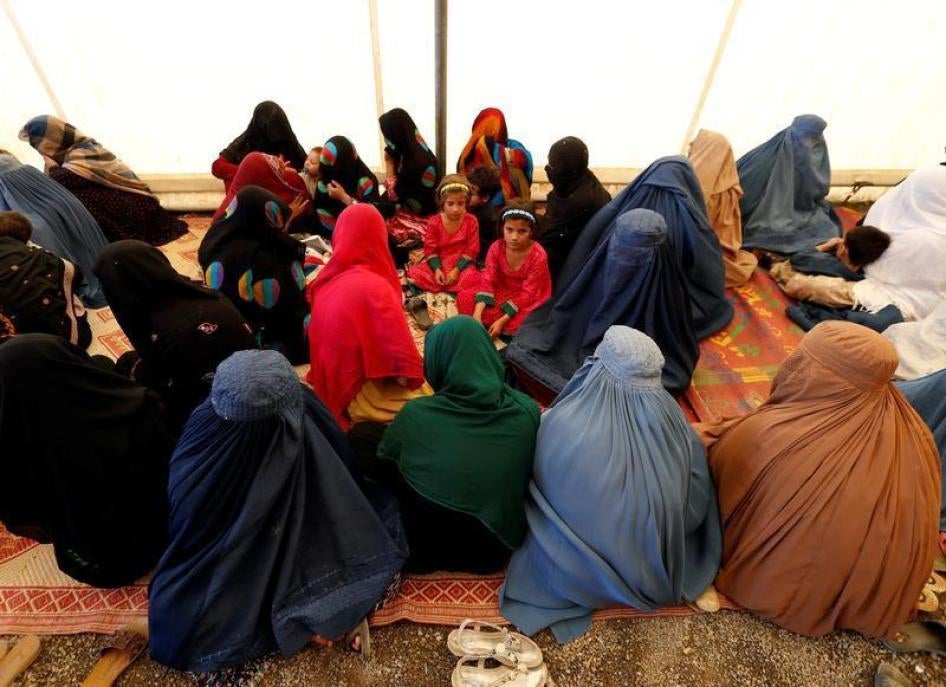 Afghan women sit with their children after arriving at a United Nations High Commissioner for Refugees (UNHCR) registration centre in Kabul, Afghanistan September 27, 2016.