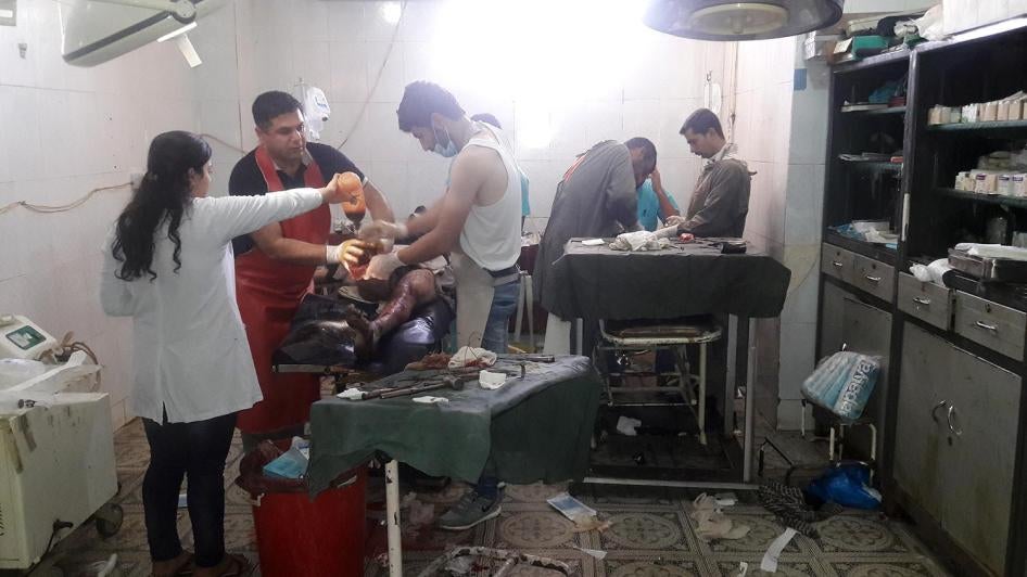Medical personnel at the Amal hospital in Kobane operate on a father and his son who were injured when a mine exploded as they were trying to flee from ISIS-controlled territory in Manbij in August. 