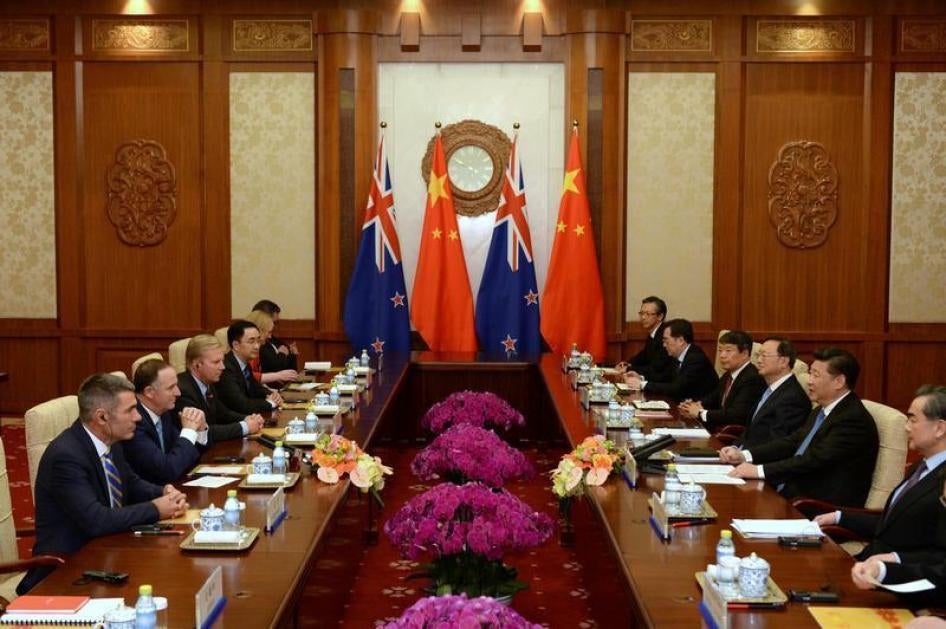 Chinese President Xi Jinping (second from right) speaks with New Zealand's Prime Minister John Key (second from left) during their meeting at the Diaoyutai State Guesthouse in Beijing, China, April 19, 2016.