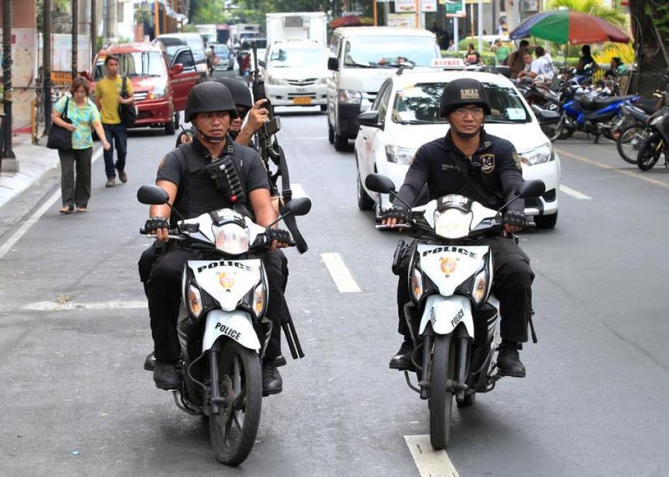 Members of the Philippine National Police (PNP) Special Weapons And Tactics (SWAT) patrol along a main street of metro Manila in the Philippines May 12, 2016.