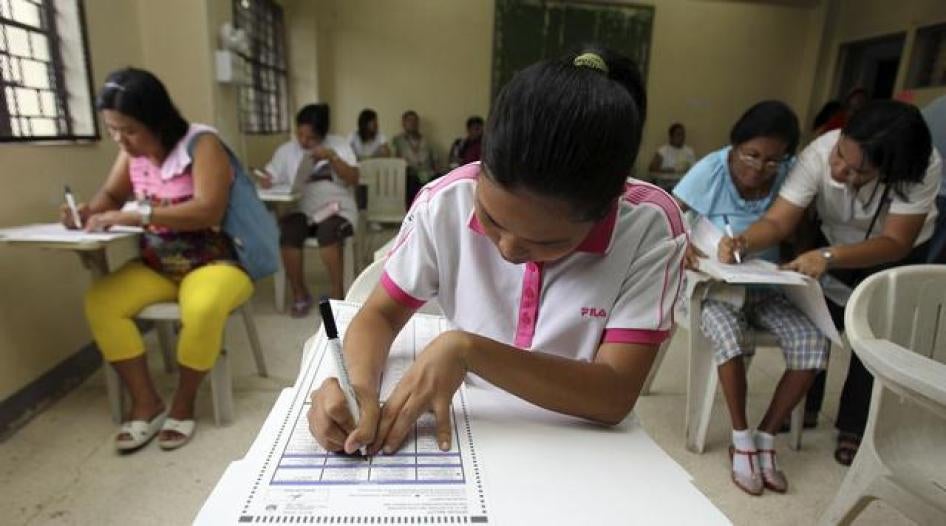 Voters fill out official ballots during the May 2010 presidential elections in the Philippines.