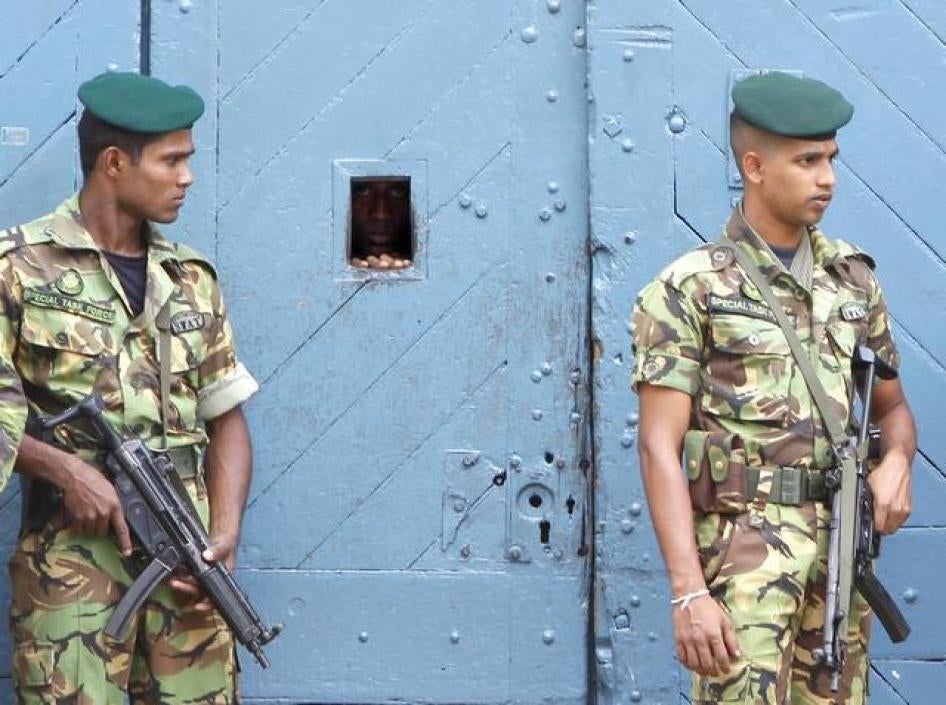 Special task force police officers stand guard outside a jail in Colombo on November 7, 2010.