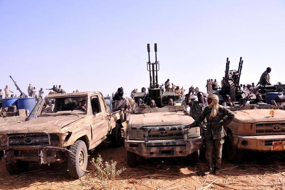 Fighters of the Sudanese Rapid Support Forces in captured vehicles celebrate a victory against the rebel Justice and Equality Movement, Goz Dango, South Darfur, April 28, 2015.   © 2015 Reuters