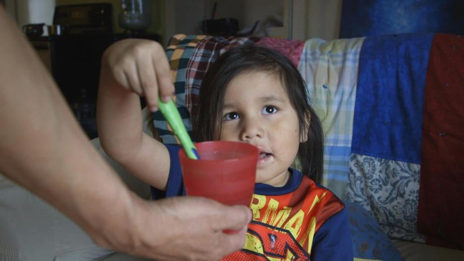 A child in Grassy Narrows First Nation, Ontario, Canada brushes her teeth with bottled water. Water on First Nations reserves is contaminated, inadequately treated or hard to access. April 14, 2016. Video Still (c) 2016 Human Rights Watch